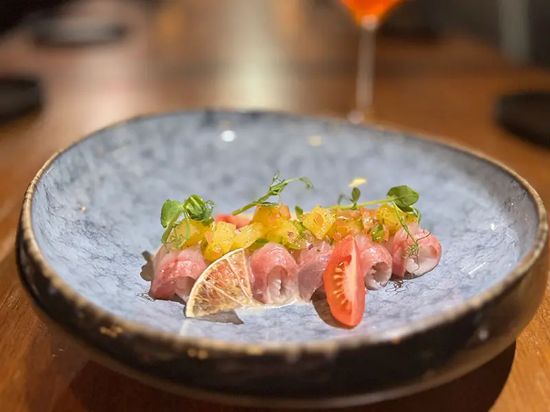 Cured snapper rolls topped with mango salsa at Umami Crudo , a Japanese Restaurant in Boston
