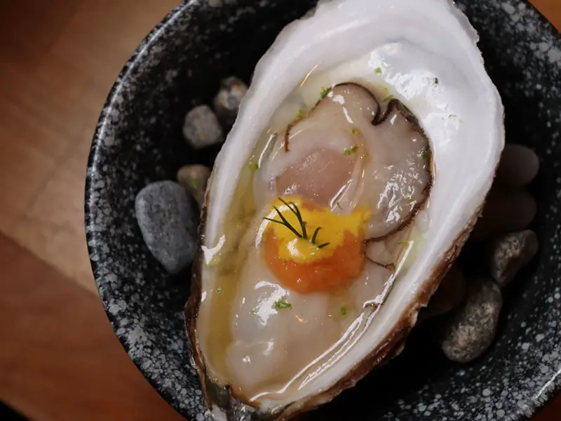 Oyster shooter with ikura & yuzu dashi at Umami Crudo , a Japanese Restaurant in Boston
